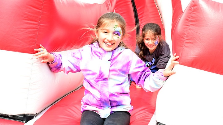 Sisters Daria and Hadiyah Chaudhry enjoy the bouncy slide