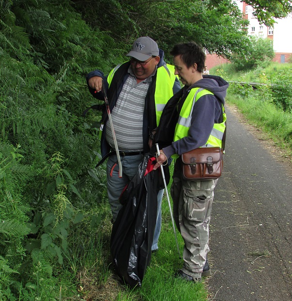 Stephen with a sighted guide litter picking